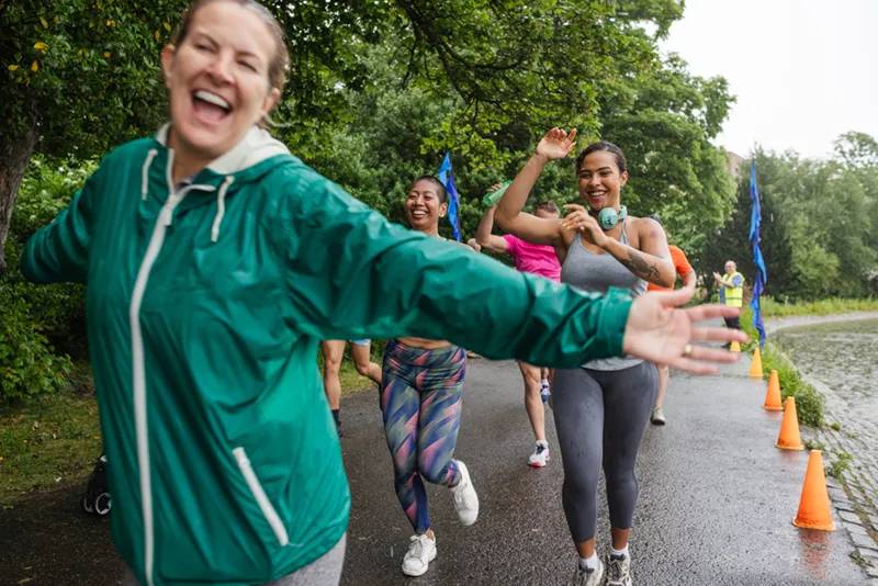 Women running a 5k with big smiles